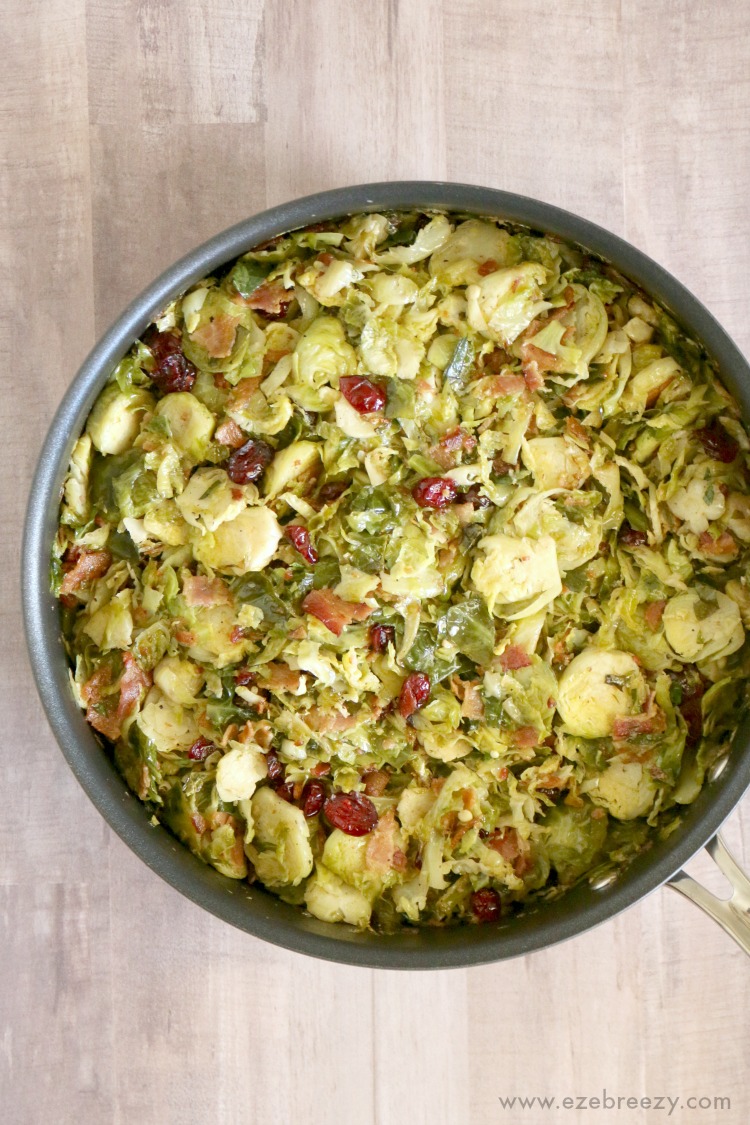  Delicious Brussels Sprouts pan-fried to perfection and tossed with sweet dried cranberries and crispy bacon; the perfect side dish for your next holiday gathering | ezebreezy.com | #Thanksgiving #Thanksgivingrecipes #sidedishes #recipes #easyrecipes #Christmasrecipes #Christmas