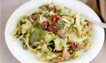 Delicious Brussels Sprouts pan-fried to perfection and tossed with sweet dried cranberries and crispy bacon; the perfect side dish for your next holiday gathering | ezebreezy.com | #Thanksgiving #Thanksgivingrecipes #sidedishes #recipes #easyrecipes #Christmasrecipes #Christmas