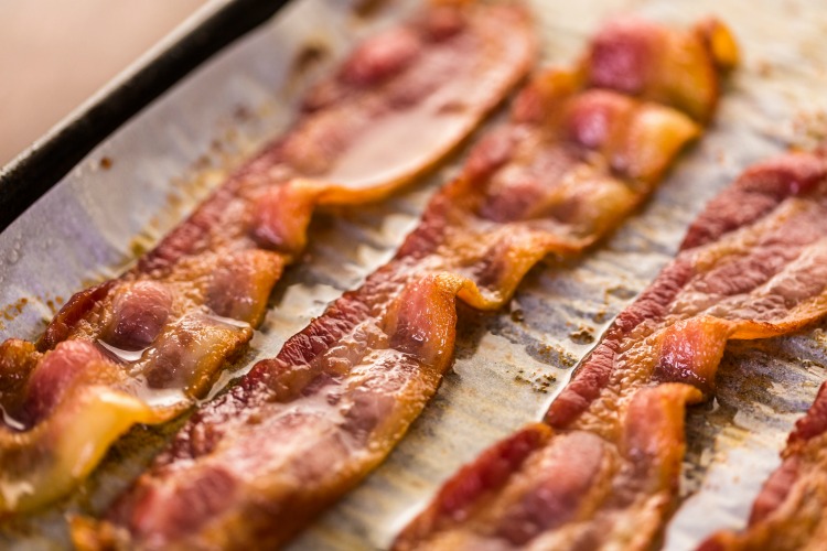 The BEST way to cook perfect bacon is in the oven. Crisp & golden brown - oven baked bacon is the way to go. Practically mess-free and ready in under 20 minutes | www.ezebreezy.com | #bacon #perfectbacon #recipe 